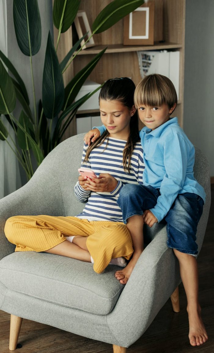Children playing mobile games at home