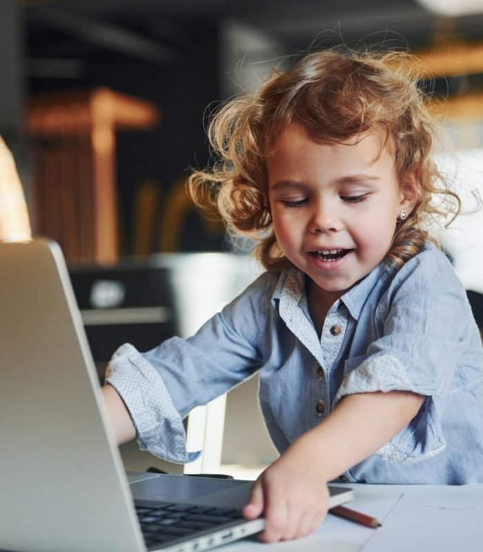 Roblox game development studio accessed by smart child using laptop for play