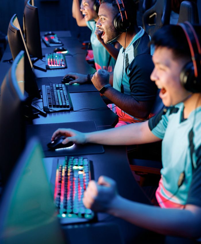 Team of gamers playing PC games in a gaming club