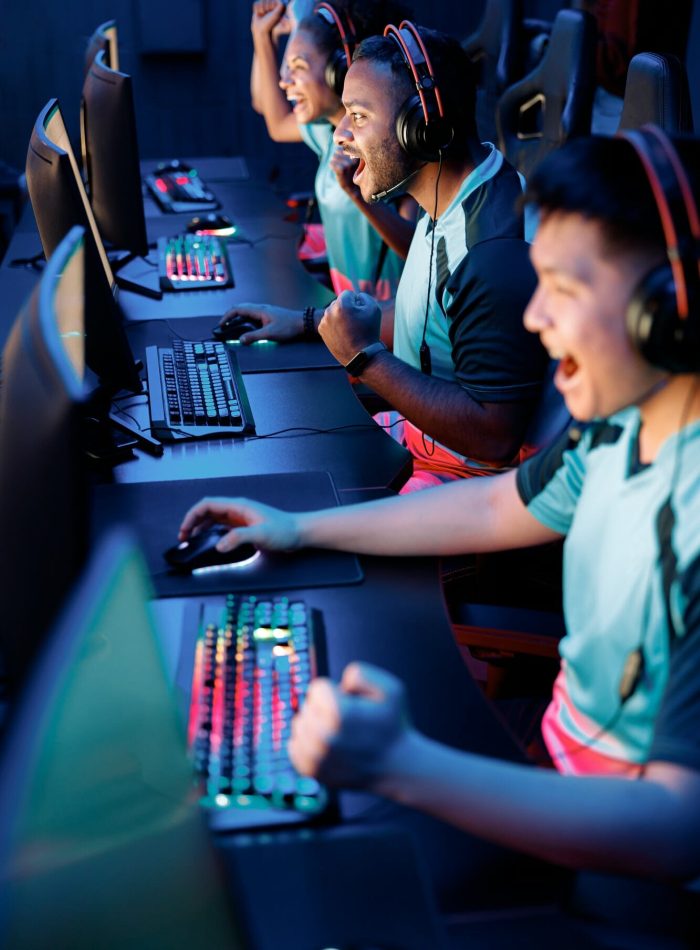 Team of gamers playing PC games in a gaming club