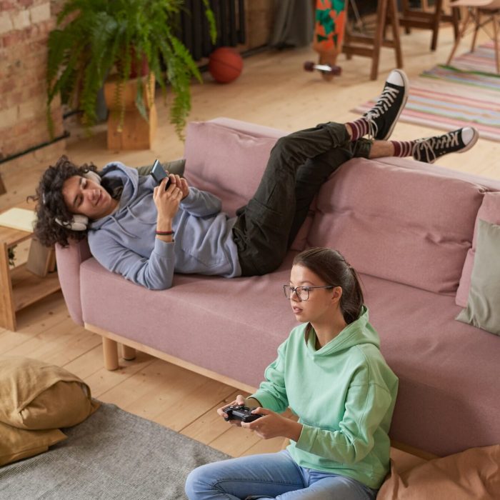 Teenagers playing mobile games through mobile game marketing agency campaigns.