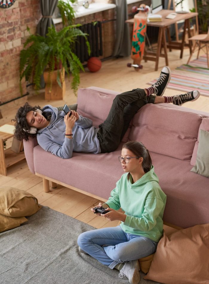 Teenagers playing mobile games through mobile game marketing agency campaigns.