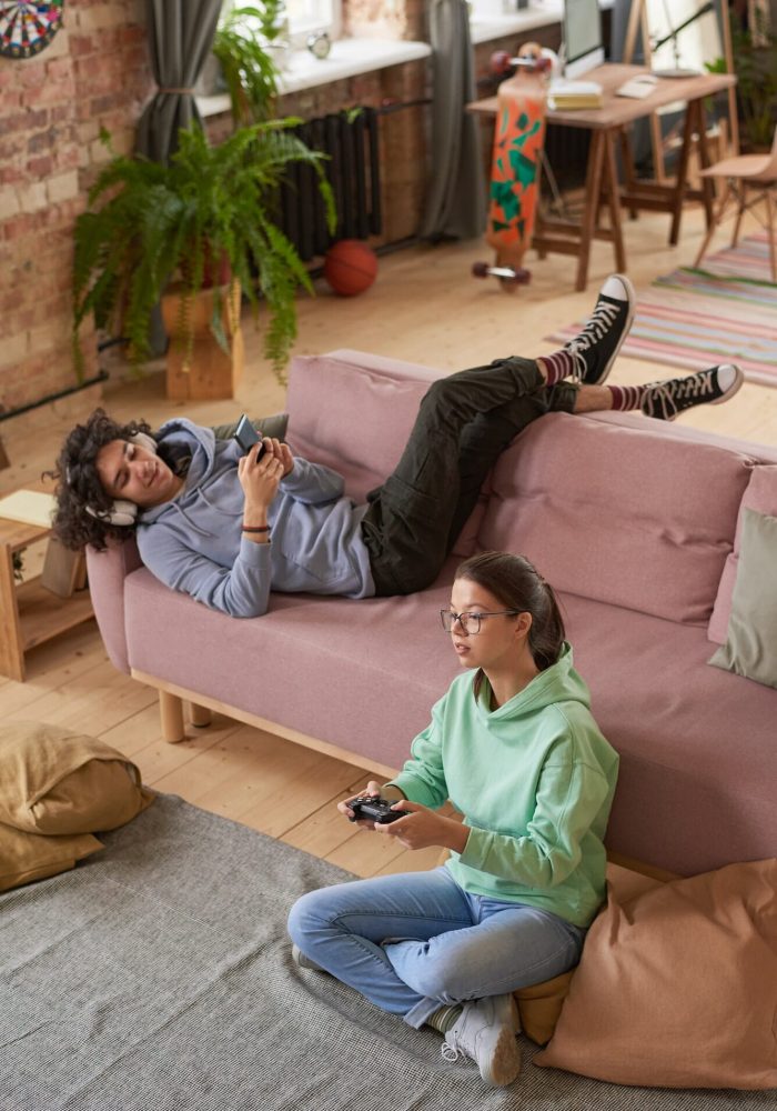 Teenagers playing mobile games through mobile game marketing agency campaigns.