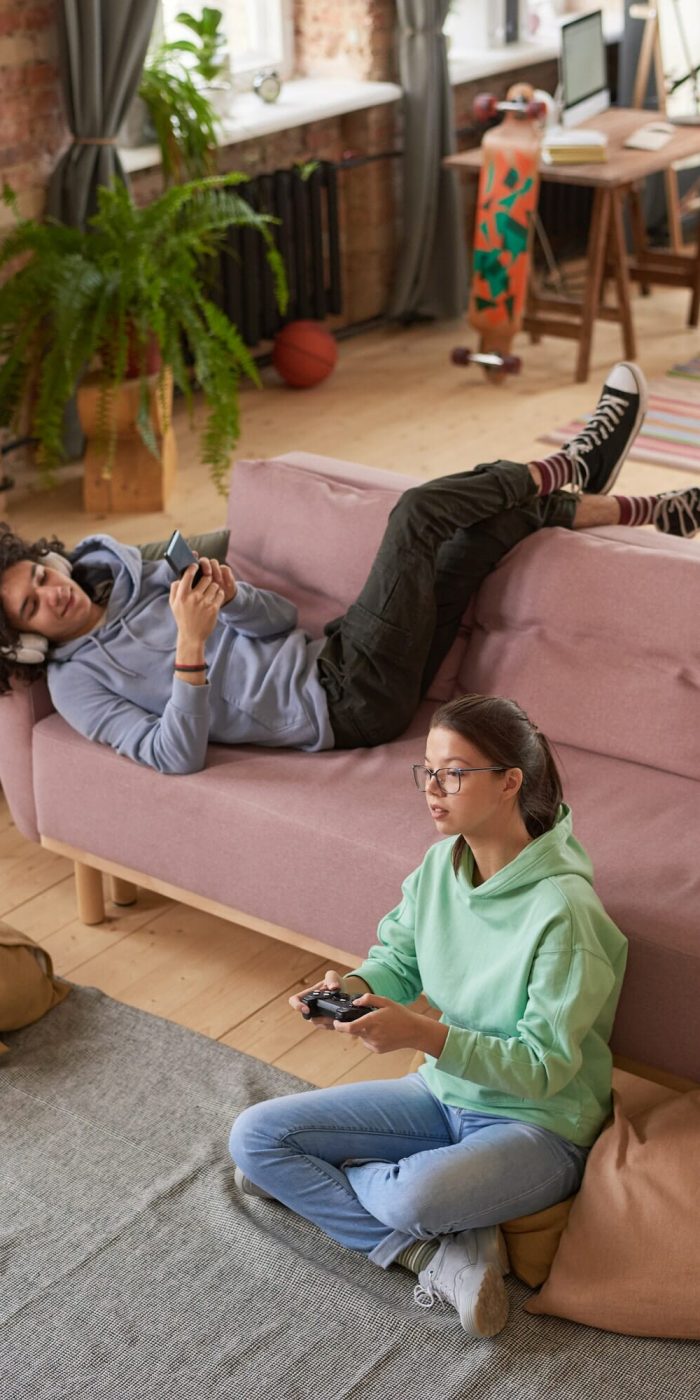 Teenagers playing mobile games through mobile game marketing agency campaigns.