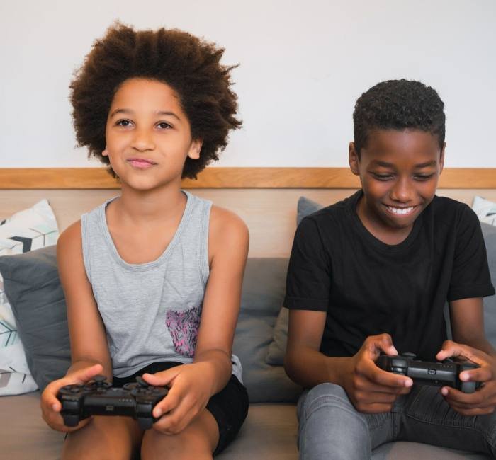 Two brothers playing video games at home.