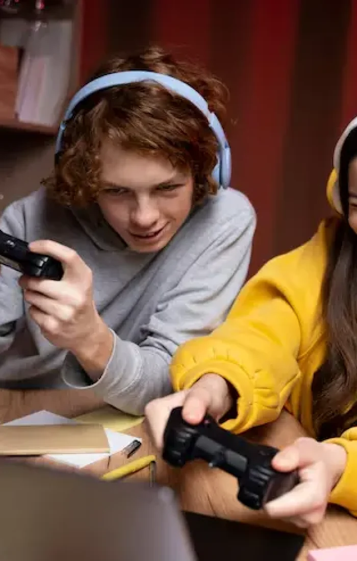two-teenage-friends-playing-video-games-together-home_23-2149332885 (1)