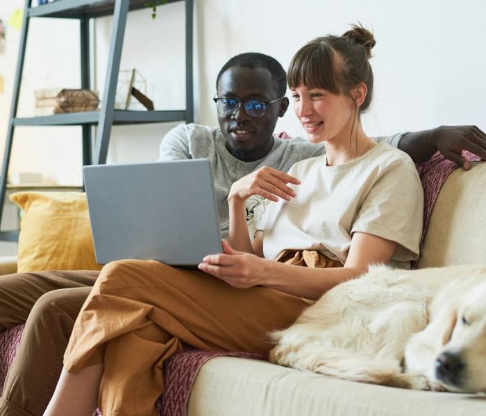 Young couple using laptop at home