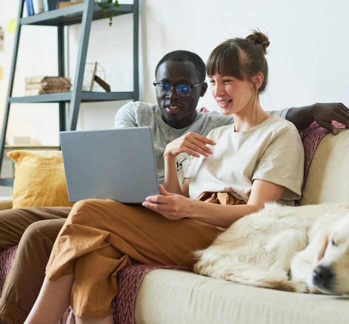 Young couple using laptop at home