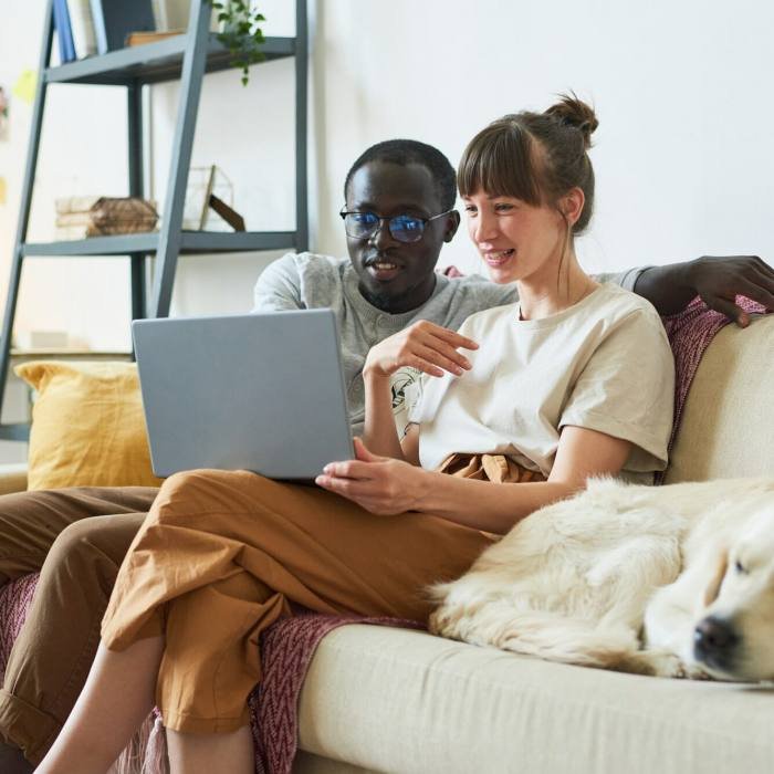 Young couple using laptop at home