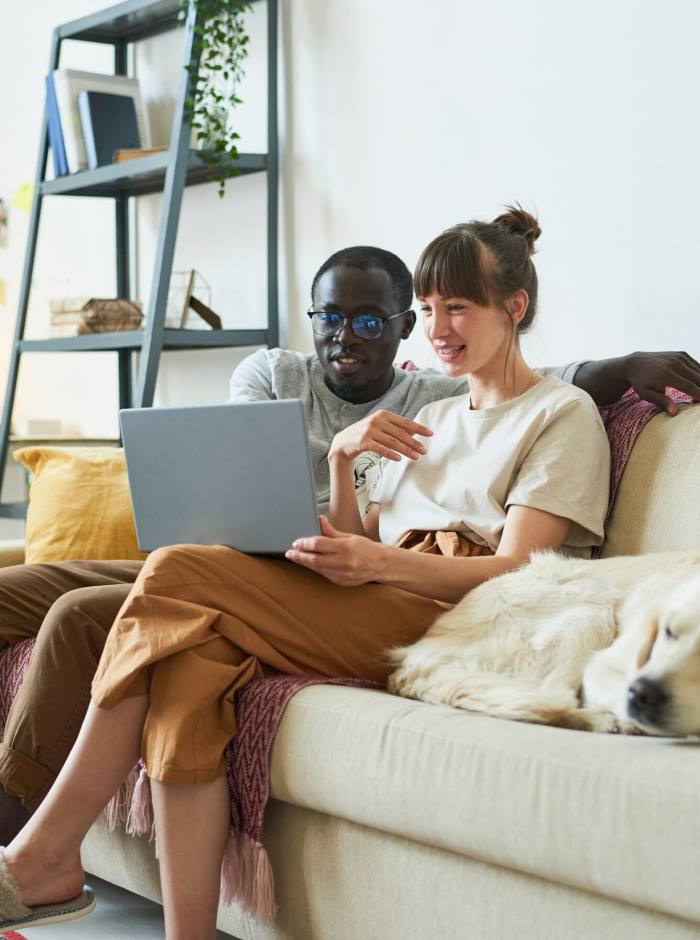 Young couple using laptop at home