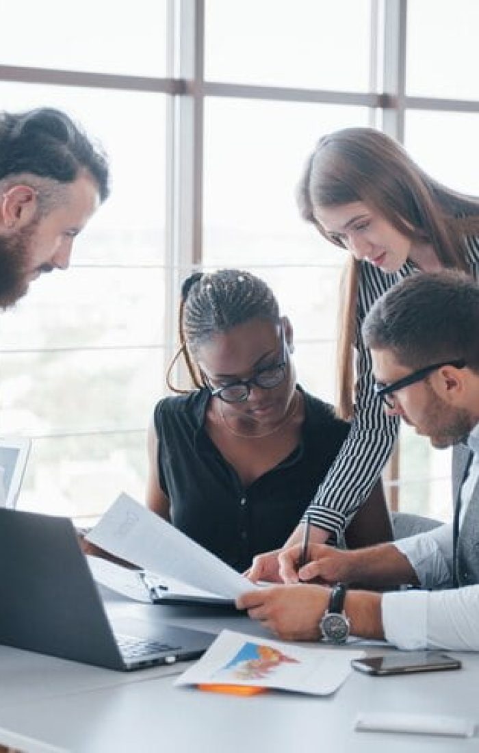 Team of Young Professionals Working Together on Laptops in Office Space